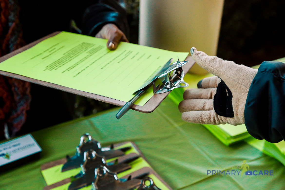 A gloved hand reaching for a clipboard